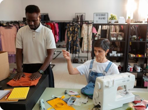 Image of healthcare worker at a desk on a laptop and virtual medical related icons floating on top
